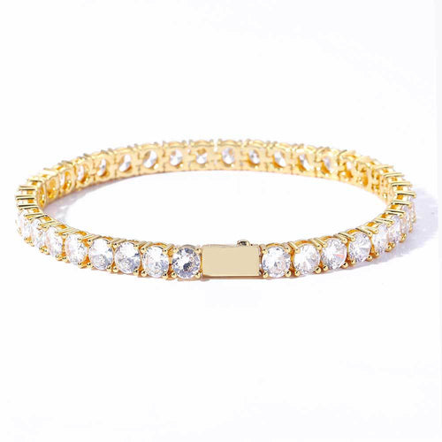 Gold tennis bracelet set with round clear stones in a continuous line on a white background.