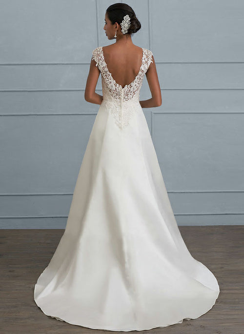 Back view of a white lace and satin A-line wedding dress with a low V-back and train.