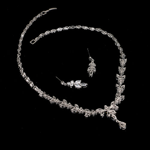 Silver-tone bridal set with a zicron crystal necklace and matching leaf-shaped drop earrings on a black background.