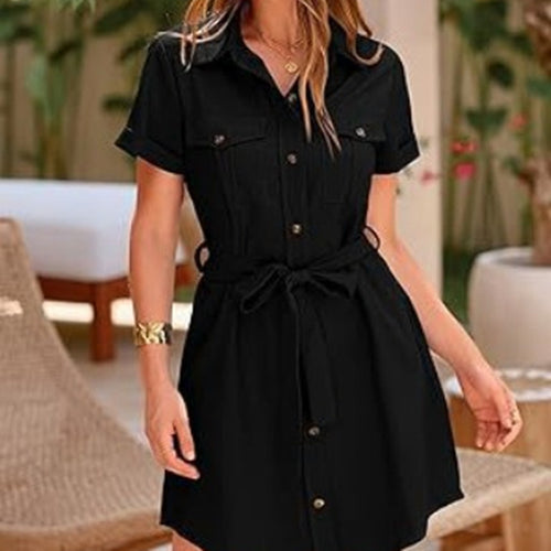 A solid black short-sleeve shirt dress with a collared neck, button front, chest pockets, and a tie belt.