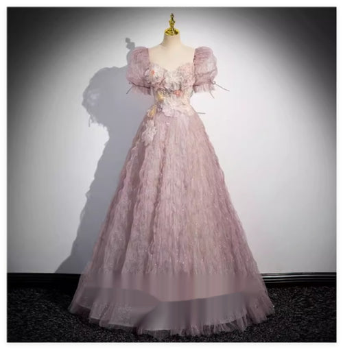 Dusty pink evening gown with puff sleeves, sweetheart neckline, and floral appliques on a mannequin.