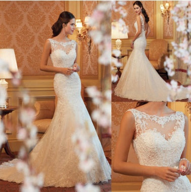 White lace mermaid wedding dress with sleeveless design, sheer neckline, and fitted silhouette.
