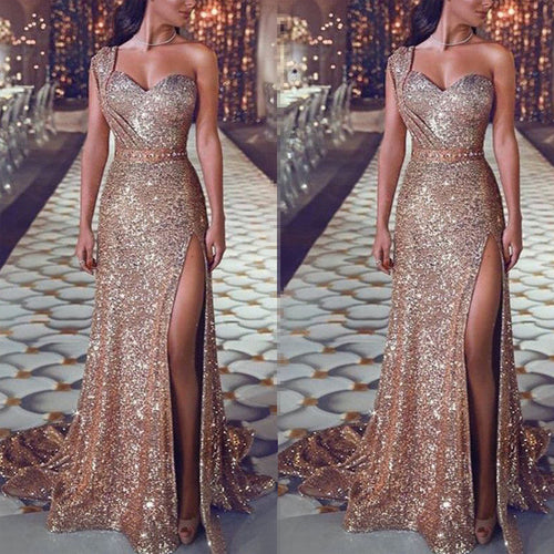 Bronze glitter one shoulder maxi dress with a high slit and floor-length train.