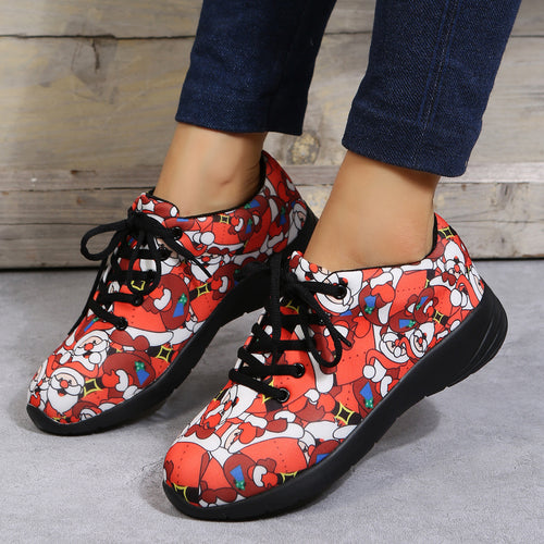 Red fabric sneakers with black laces and soles feature an all-over Santa Claus print.
