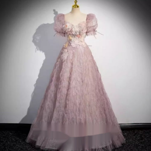 Dusty pink silk evening gown on a mannequin, featuring puffed sleeves, a sweetheart neckline, and floral bodice details.