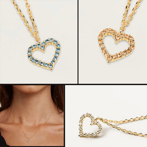Gold-tone chain necklaces with hollow heart pendants, featuring blue, amber, or clear stones.