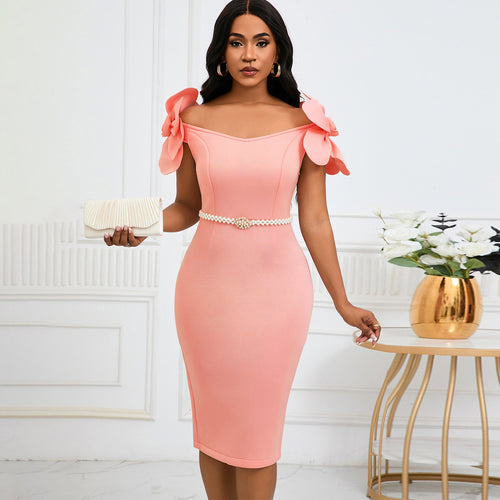 Model wearing a pink off-the-shoulder midi dress with 3D floral sleeves and a pearl belt, holding a clutch.